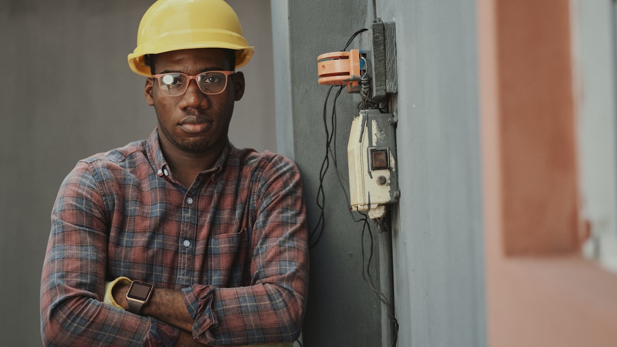 HVAC technician repairing an air conditioning unit on a rooftop